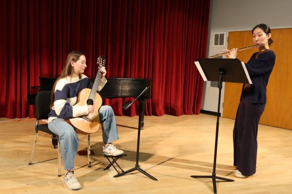 Student guitarist and flutist in Brechemin Auditorium (Joanne DePue photo).