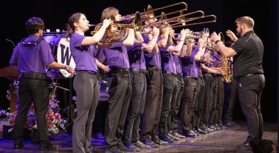 School of Music alumnus Corey Jahlas leads the Husky Marching Band (Photo: UW Photography). 