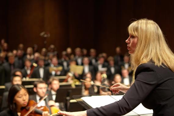 Giselle Wyers conducting the combined UW symphony and choirs (Photo: Steve Korn).