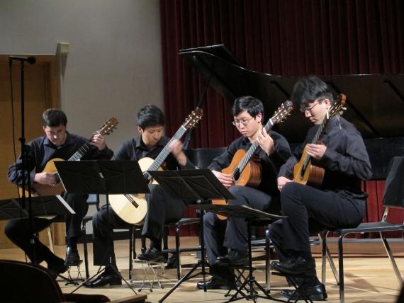 UW Guitar Ensemble students playing guitars