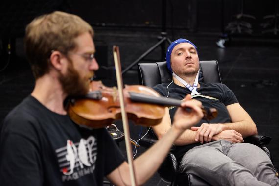 Music/DXARTS postdoc Marcin Pączkowski prepares JACK Quartet violinist Austin Wulliman for an EEG session