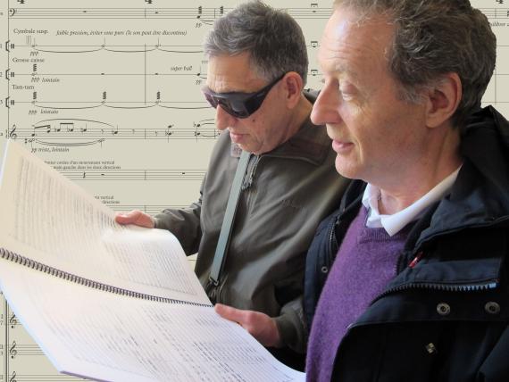 Professors Joël-François Durand (right) and Larry Starr peruse the score of Durand's new commission for Seattle Symphony (Photo: Joanne DePue). 