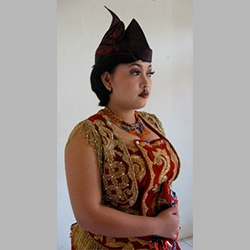 A female dancer models the costume for the male-style dance Ngremo Tayub. Photo by Christina Sunardi.