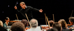 Ludovic Morlot conducting a side by side concert featuring the Seattle Symphony and UW Symphony Orchestra.