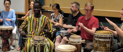 Teachers drumming during the world music pedagogy workshop.