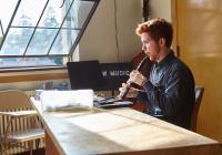 Oboist works on reedmaking.