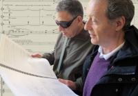 Professors Joël-François Durand (right) and Larry Starr peruse the score of Durand's new commission for Seattle Symphony (Photo: Joanne DePue). 