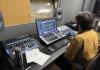A UW student works at the recording console in Control Room A (Photo: Coen Rios).