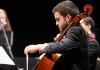 Student musician playing a cello.