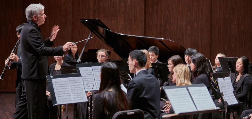 Timothy Salzman conducts the UW Wind Ensemble (photo Steve Korn)