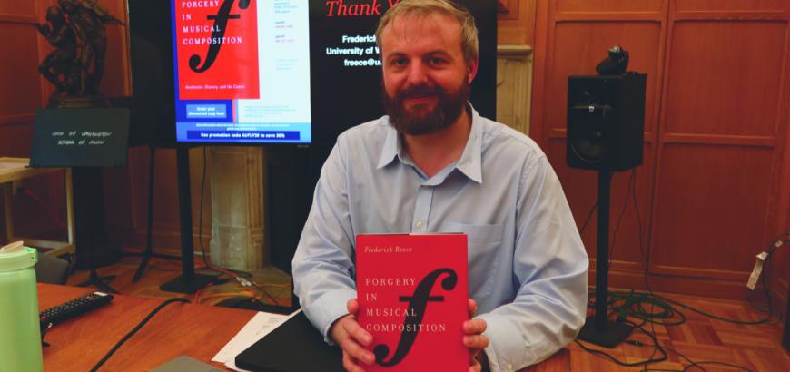 Assistant Professor Frederick Reece and his book Forgery in Musical Composition (Photo: Joanne DePue).