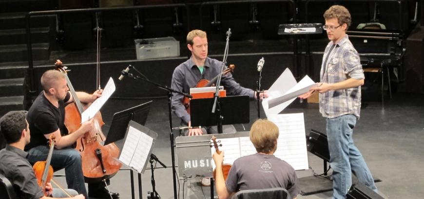 Composition student Josh Archibald-Seiffer receives notes from the JACK Quartet