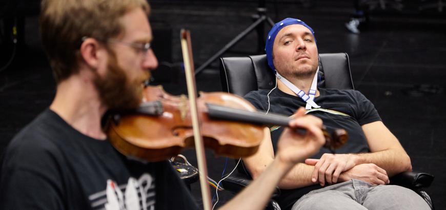 Music/DXARTS postdoc Marcin Pączkowski prepares JACK Quartet violinist Austin Wulliman for an EEG session