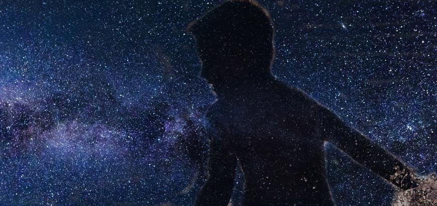 Boy swimming in stars