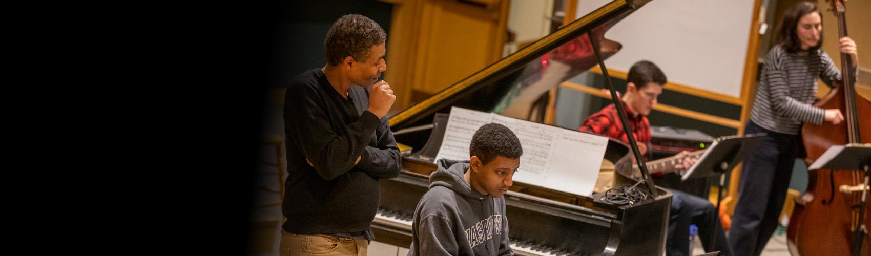 Faculty and student creating and playing music