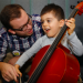 Young boy learning cello