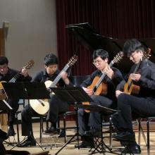 UW Guitar Ensemble students playing guitars